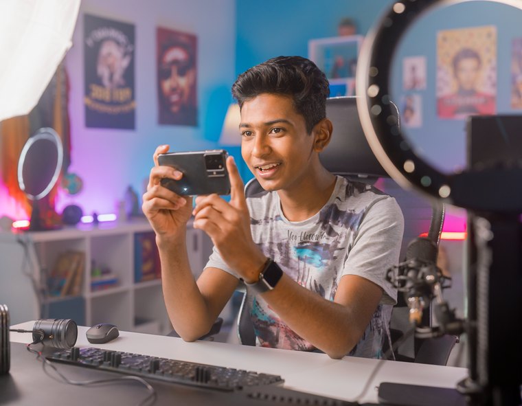 A student filming a video in his room